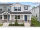 Charming townhome featuring a covered porch with stone accents and blue shutters at 1299 Tarflower Dr, Winter Springs, FL 32708