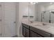 Well-lit bathroom featuring double sinks, modern vanity, and a glass-enclosed shower at 14007 Picard Aly, Winter Garden, FL 34787