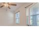 Bright and airy bedroom with large windows offering plenty of natural light and a ceiling fan at 14007 Picard Aly, Winter Garden, FL 34787