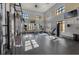 Well-equipped gym featuring various exercise machines, natural light, and TVs for entertainment at 14007 Picard Aly, Winter Garden, FL 34787