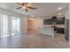 Open-concept living space with sleek tile flooring, abundant natural light, and access to outdoor patio at 14007 Picard Aly, Winter Garden, FL 34787