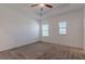 Spacious main bedroom with neutral carpeting, tray ceiling, and two windows for natural light at 14007 Picard Aly, Winter Garden, FL 34787