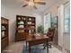 Comfortable office space with built in bookcases and large desk in front of a bright window at 14007 Picard Aly, Winter Garden, FL 34787