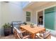Outdoor patio featuring a stainless steel grill, dining table, and sliding glass door access to the home's interior at 14007 Picard Aly, Winter Garden, FL 34787