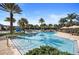 Resort-style swimming pool with palm trees, lounge chairs, and a water slide at 14007 Picard Aly, Winter Garden, FL 34787