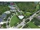 Aerial view of the community pool with a cabana, lush landscaping, and surrounding residential area at 14252 Anastasia Ln, Orlando, FL 32828