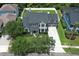 Expansive aerial view of a well-manicured home featuring mature trees and a spacious driveway at 14252 Anastasia Ln, Orlando, FL 32828