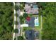 A high angle view of a home with a swimming pool and green lawn surrounded by lush trees at 14252 Anastasia Ln, Orlando, FL 32828