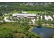 Aerial view showcases the community's school surrounded by lush landscapes, tranquil ponds, and neighborhood homes at 14252 Anastasia Ln, Orlando, FL 32828