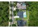 A high angle view of a home with a swimming pool and green lawn surrounded by lush trees at 14252 Anastasia Ln, Orlando, FL 32828