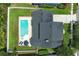 An aerial shot showcasing a backyard with a pool, patio and well maintained lawn in the sun at 14252 Anastasia Ln, Orlando, FL 32828