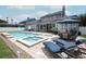 Luxurious backyard with a swimming pool, spa, and comfortable lounge chairs at 14252 Anastasia Ln, Orlando, FL 32828