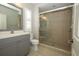 This bathroom offers a glass enclosed walk-in shower and granite countertop vanity at 14252 Anastasia Ln, Orlando, FL 32828