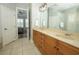 Bright bathroom featuring double sinks, decorative lighting and a view of the bedroom at 14252 Anastasia Ln, Orlando, FL 32828