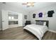 This bedroom features wood look flooring, a ceiling fan, and an adjacent bonus room at 14252 Anastasia Ln, Orlando, FL 32828