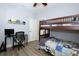 Bright bedroom with a bunk bed, desk, and sleek gray flooring at 14252 Anastasia Ln, Orlando, FL 32828