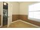 Bedroom with decorative wall panels and tan carpet at 14252 Anastasia Ln, Orlando, FL 32828