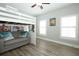 Cozy bedroom with sofa, two windows, and a ceiling fan above bunk beds at 14252 Anastasia Ln, Orlando, FL 32828