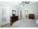 This bedroom has a ceiling fan, wood floors, and is bright with natural light at 14252 Anastasia Ln, Orlando, FL 32828