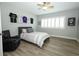 This bedroom features wood look flooring, a ceiling fan, and plantation shutters at 14252 Anastasia Ln, Orlando, FL 32828
