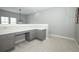 Neutral bonus room features a built in desk and storage, neutral carpet, and light grey walls at 14252 Anastasia Ln, Orlando, FL 32828