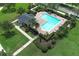 Aerial view showcasing the community pool with its unique shape, cabana, lounge chairs, and manicured landscaping at 14252 Anastasia Ln, Orlando, FL 32828
