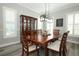 The dining room features natural light, and an elegant light fixture above the table at 14252 Anastasia Ln, Orlando, FL 32828