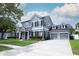 Beautiful home features a three car garage, well manicured lawn, and attractive landscaping at 14252 Anastasia Ln, Orlando, FL 32828