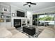 Lovely living room with fireplace, built-in shelving, sliding glass door to patio, and gray hardwood floors at 14252 Anastasia Ln, Orlando, FL 32828
