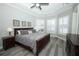 Calming main bedroom with hardwood floors, tray ceilings, neutral paint, and windows with plantation shutters at 14252 Anastasia Ln, Orlando, FL 32828