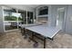 Covered outdoor living space featuring ping pong table and summer kitchen at 14252 Anastasia Ln, Orlando, FL 32828