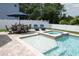 This backyard oasis has a sunshelf with water feature, adjacent spa, and dining area for outdoor entertaining at 14252 Anastasia Ln, Orlando, FL 32828