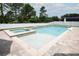 Beautiful backyard featuring a modern pool, spa, and sun shelf, ideal for enjoying sunny days at 14252 Anastasia Ln, Orlando, FL 32828