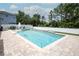 Inviting in-ground pool with a basketball hoop and surrounding patio, perfect for outdoor relaxation and entertainment at 14252 Anastasia Ln, Orlando, FL 32828