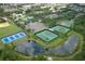 Overhead view highlighting the community's recreational facilities, including tennis courts, baseball field, and pond at 14252 Anastasia Ln, Orlando, FL 32828