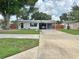 Charming single-story home featuring a carport, well-maintained lawn, and mature trees at 1428 Glendale St, Lakeland, FL 33803