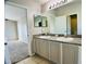 Bathroom featuring double sinks, mirror, and tile floors at 1433 Bluff Loop, Dundee, FL 33838