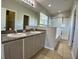 Bathroom featuring double sink vanity, large mirror, and glass enclosed shower at 1433 Bluff Loop, Dundee, FL 33838