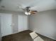 Bedroom with carpet flooring, closet, ceiling fan, and natural lighting at 1433 Bluff Loop, Dundee, FL 33838