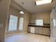 Bright kitchen with tile floor, white appliances, and breakfast nook at 1433 Bluff Loop, Dundee, FL 33838