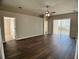 Spacious living room with wood flooring, ceiling fan, and sliding door to patio at 1433 Bluff Loop, Dundee, FL 33838