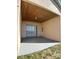 Covered patio featuring a sliding glass door entry and exterior door, perfect for outdoor relaxation at 1433 Bluff Loop, Dundee, FL 33838