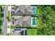 Aerial view of a community with a private pool, backyard, solar panels and lush green landscaping at 15343 Lebeau Loop, Winter Garden, FL 34787