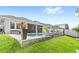 Backyard features a pool, patio, lush lawn, and well-maintained landscaping at 15343 Lebeau Loop, Winter Garden, FL 34787