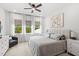 Sun-filled bedroom featuring a king-sized bed, stylish decor, and plush carpet flooring at 15343 Lebeau Loop, Winter Garden, FL 34787