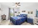 Charming bedroom with vibrant decor, natural light, and dark wood furniture with a ceiling fan at 15343 Lebeau Loop, Winter Garden, FL 34787