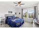 Stylish bedroom with bright natural light, game themed decor, and modern ceiling fan at 15343 Lebeau Loop, Winter Garden, FL 34787