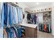 Spacious walk-in closet with custom shelving and ample storage for clothes and shoes at 15343 Lebeau Loop, Winter Garden, FL 34787