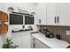 Close up of the coffee bar area with designer backsplash, decorative shelving, and custom cabinetry at 15343 Lebeau Loop, Winter Garden, FL 34787