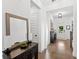 Inviting entryway featuring hardwood floors, a decorative mirror, and a stylish console table at 15343 Lebeau Loop, Winter Garden, FL 34787